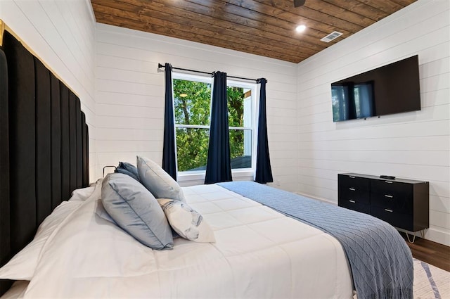 bedroom featuring wood ceiling, wooden walls, and wood-type flooring