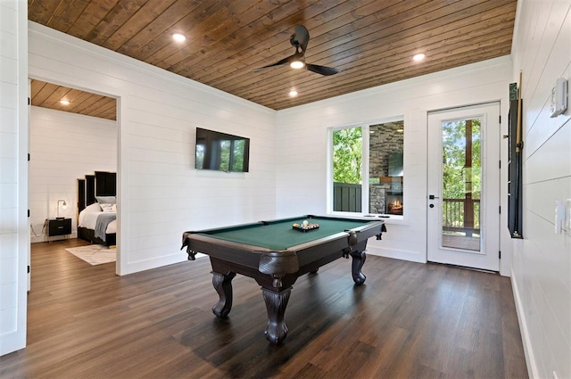 recreation room with dark hardwood / wood-style flooring, wood ceiling, ceiling fan, a stone fireplace, and pool table