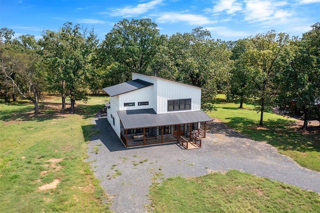 view of front of house with a porch and a front yard