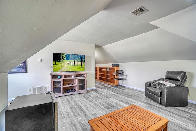 1405 Rosehaven Dr, Altus, OK 73521 - living room featuring wood finished floors and vaulted ceiling