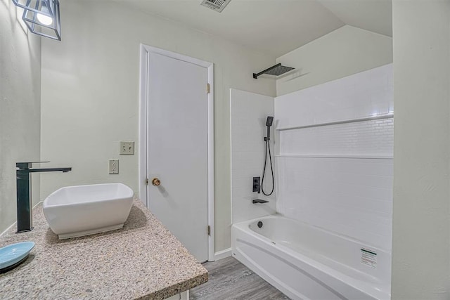 1405 Rosehaven Dr, Altus, OK 73521 - full bath featuring vanity, washtub / shower combination, and wood finished floors