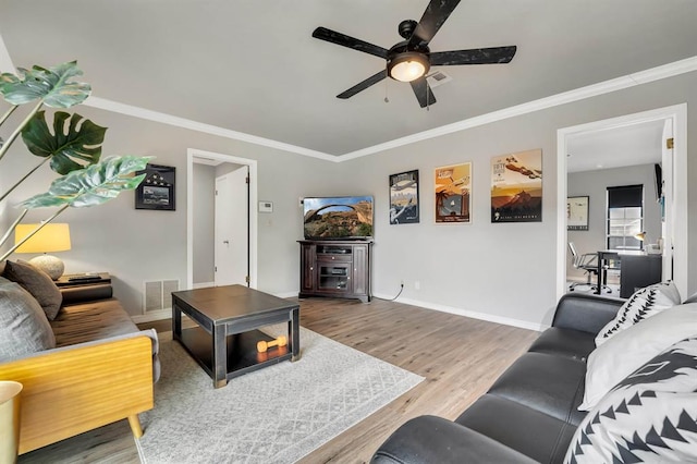 1405 Rosehaven Dr, Altus, OK 73521 - living room with wood finished floors, ceiling fan, and crown molding