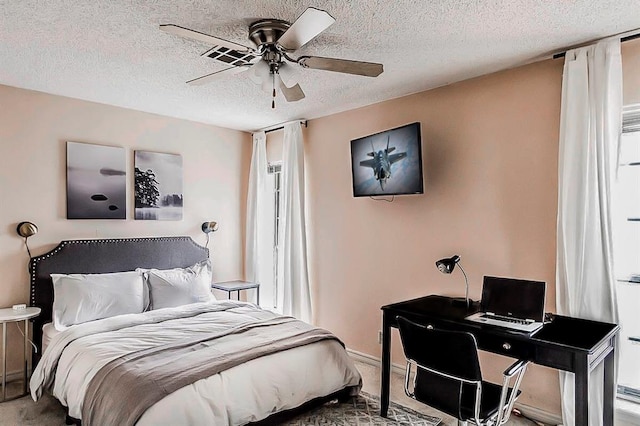 1405 Rosehaven Dr, Altus, OK 73521 - bedroom featuring a textured ceiling, a ceiling fan, and carpet floors