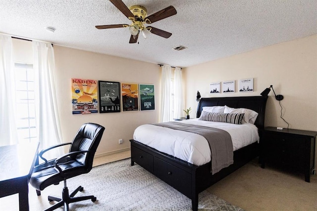 1405 Rosehaven Dr, Altus, OK 73521 - bedroom featuring carpet floors, multiple windows, a textured ceiling, and a ceiling fan