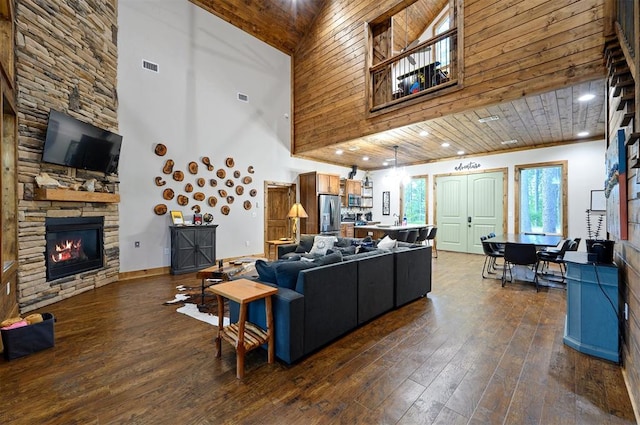 living room featuring a fireplace, high vaulted ceiling, wooden ceiling, and dark hardwood / wood-style floors