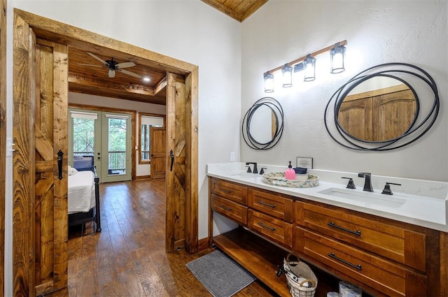 bathroom featuring hardwood / wood-style floors, ceiling fan, crown molding, and vanity