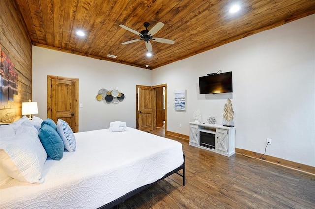 bedroom with ceiling fan, dark hardwood / wood-style flooring, and wooden ceiling