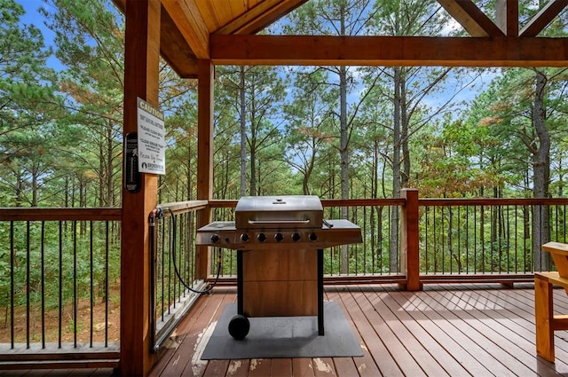 wooden terrace with a grill