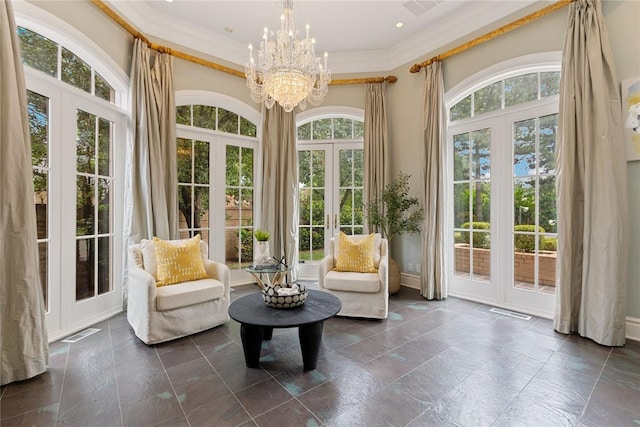 sunroom / solarium featuring plenty of natural light, a chandelier, and french doors