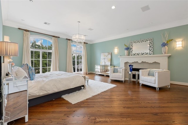 bedroom with dark hardwood / wood-style flooring, crown molding, and an inviting chandelier