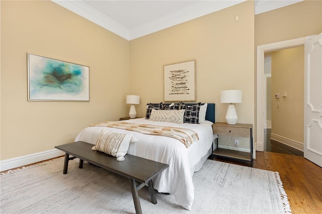 bedroom featuring crown molding and hardwood / wood-style floors