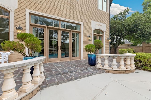 property entrance with a patio area and french doors