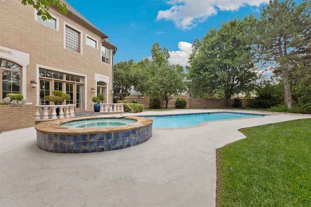 view of swimming pool with an in ground hot tub