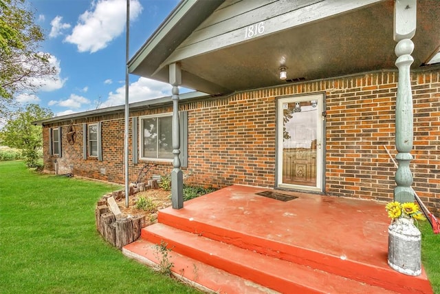 doorway to property with a lawn