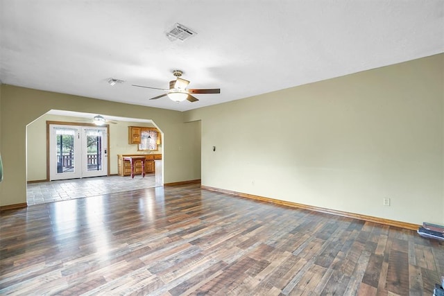 unfurnished living room with wood-type flooring, french doors, and ceiling fan