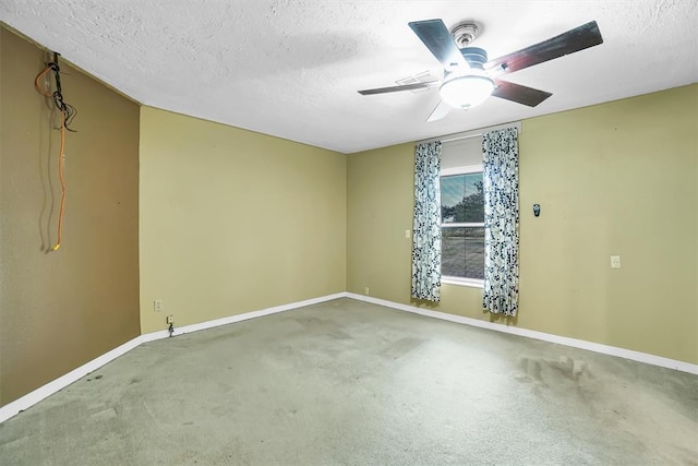 carpeted spare room with ceiling fan and a textured ceiling