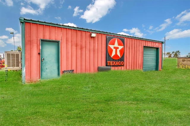 view of outbuilding with a yard