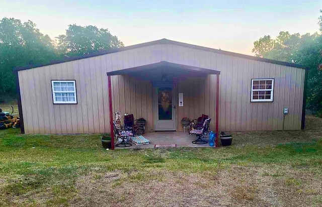 outdoor structure at dusk with a yard