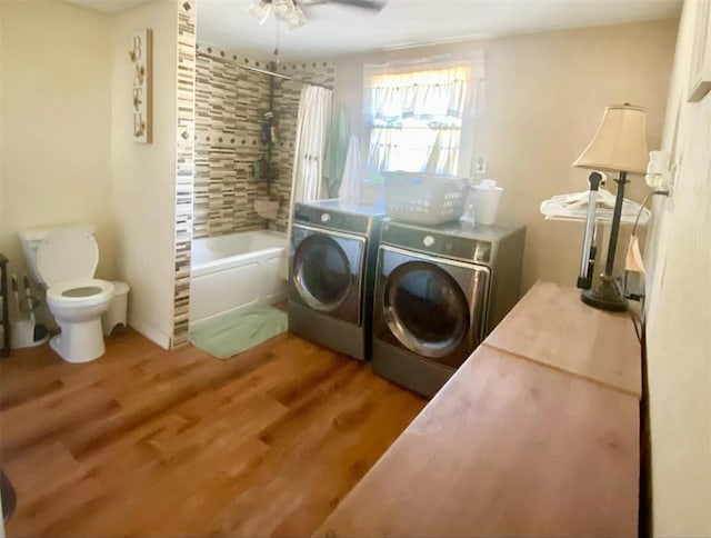 laundry area with hardwood / wood-style flooring, washer and dryer, and ceiling fan