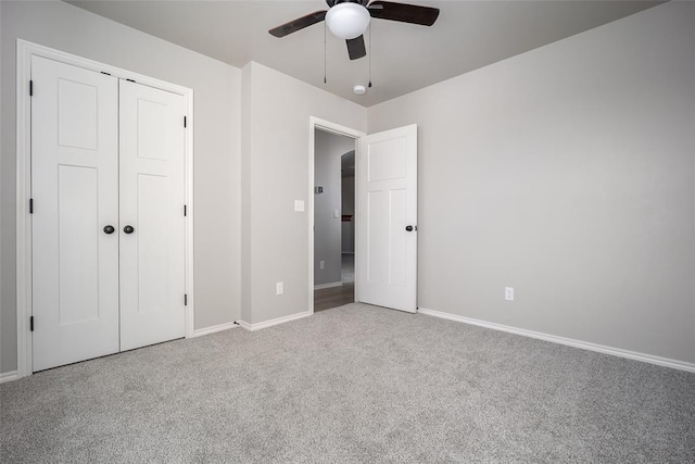 unfurnished bedroom with a closet, ceiling fan, and carpet flooring