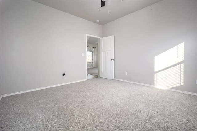 carpeted spare room featuring ceiling fan