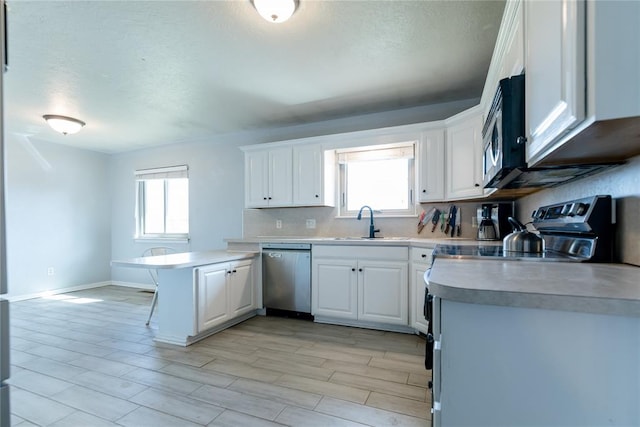 kitchen featuring white cabinetry, plenty of natural light, and stainless steel appliances