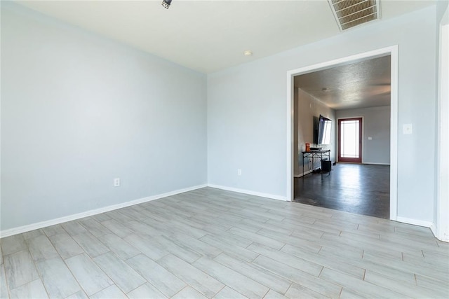 spare room with light hardwood / wood-style flooring