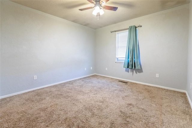 empty room with ceiling fan and carpet