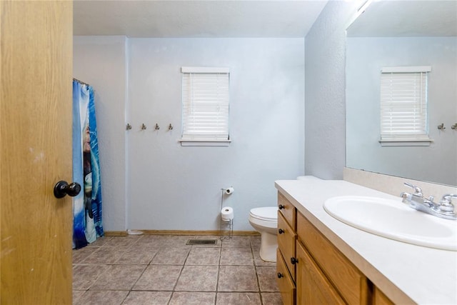 bathroom featuring tile patterned floors, vanity, and toilet