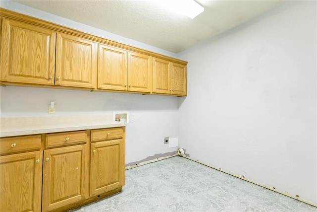 laundry area featuring cabinets, washer hookup, a textured ceiling, and hookup for an electric dryer