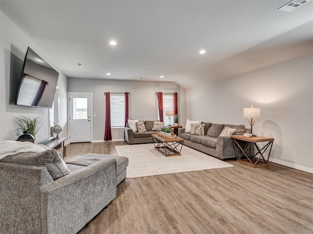 living room featuring hardwood / wood-style floors and vaulted ceiling