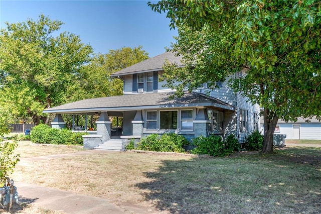 view of front of house featuring covered porch and a front yard