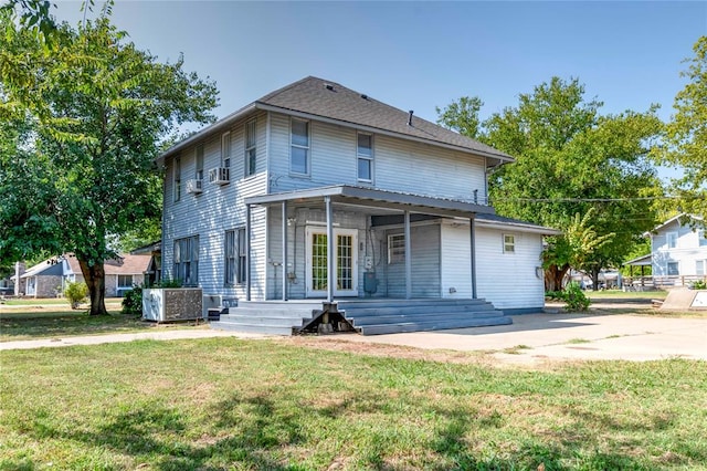 view of front of home featuring central air condition unit and a front lawn