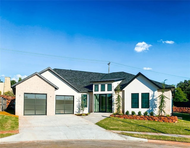 modern farmhouse with a front lawn and a garage