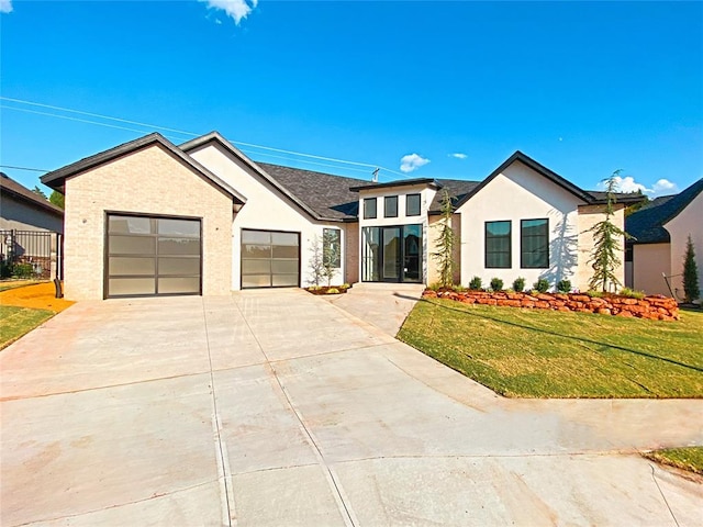 view of front facade featuring a garage and a front lawn