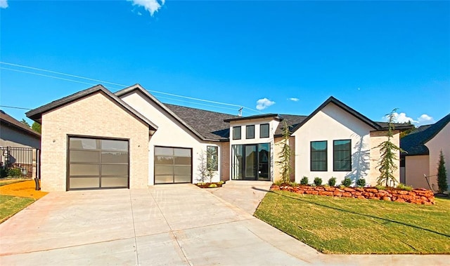 view of front of property featuring a garage and a front lawn