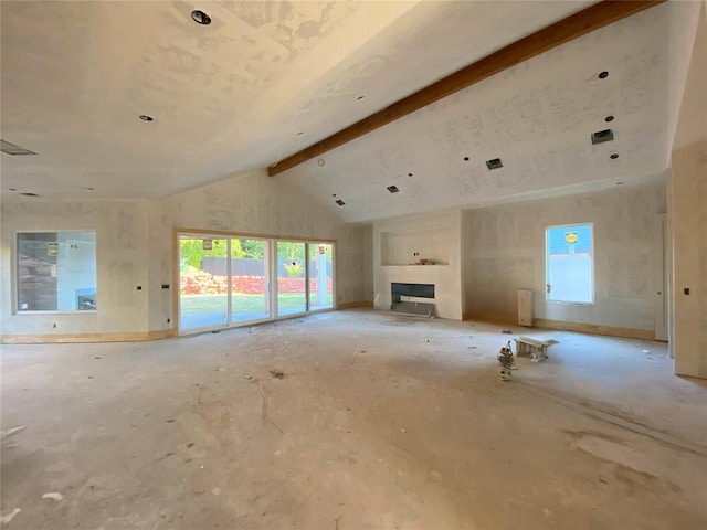 unfurnished living room with beam ceiling and high vaulted ceiling