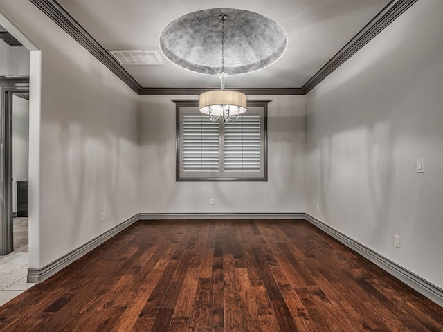 spare room with ornamental molding, a notable chandelier, and hardwood / wood-style flooring