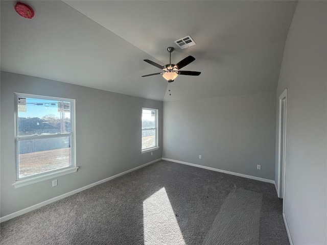 carpeted spare room with ceiling fan and lofted ceiling