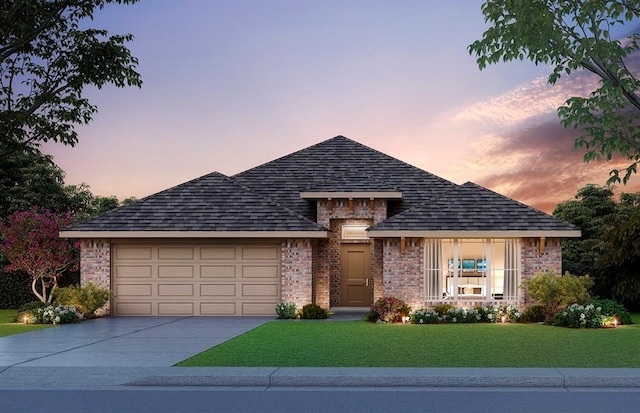 view of front of home with a lawn and a garage