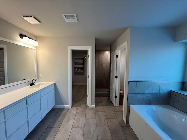 bathroom featuring independent shower and bath and vanity