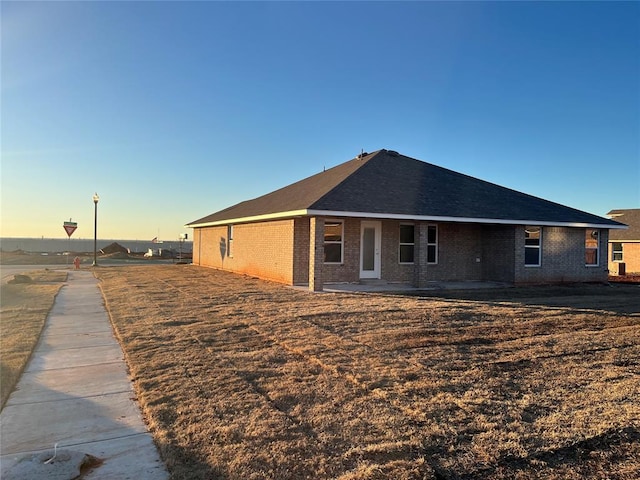 view of back house at dusk