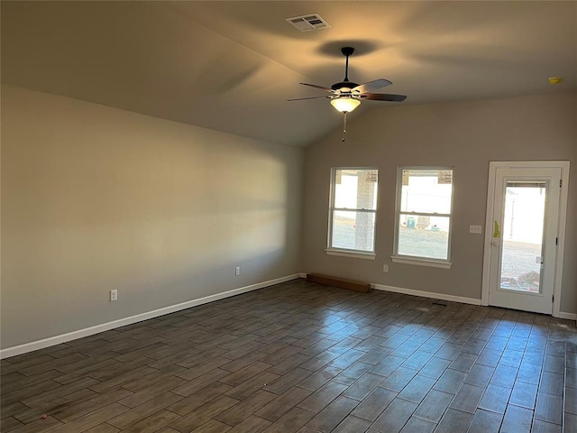 empty room with ceiling fan, dark wood-type flooring, and vaulted ceiling