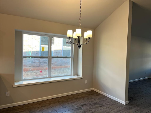 unfurnished dining area with a notable chandelier, dark hardwood / wood-style floors, and vaulted ceiling