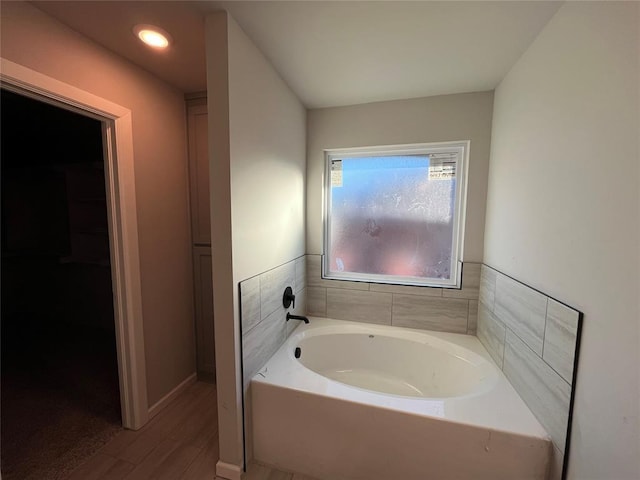 bathroom featuring a washtub and wood-type flooring