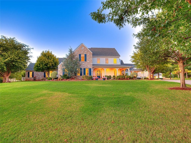 colonial-style house with a front yard