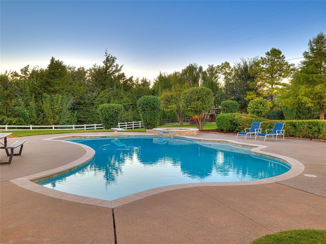 view of swimming pool with a patio area and an in ground hot tub