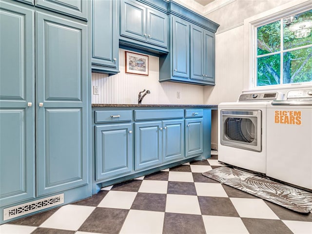 laundry area with cabinets, independent washer and dryer, and crown molding