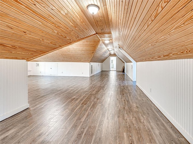 bonus room with lofted ceiling, hardwood / wood-style flooring, wooden ceiling, and wood walls