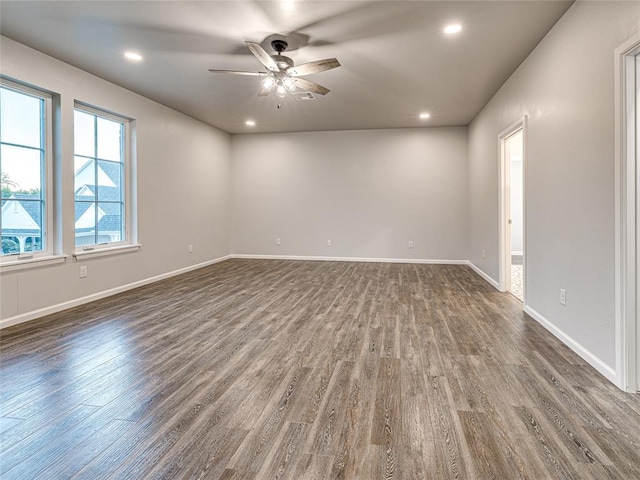 empty room with ceiling fan and dark hardwood / wood-style floors